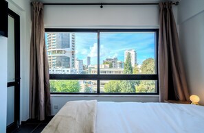 A tranquil retreat featuring a comfy bed, stunning views, and modern style.