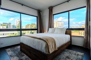 Relax in a plush queen bed with soft linens for ultimate comfort and rest.
