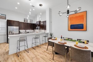 Well appointed kitchen, a kitchen island, and 8 seater dining table.