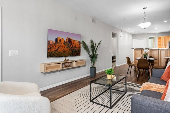 Stylish living room with comfortable double sofa bed, working station, dining area.