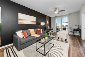 Stylish living room with comfortable double sofa bed, working station, dining area.