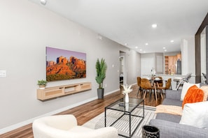 Stylish living room with comfortable double sofa bed, working station and private patio.
