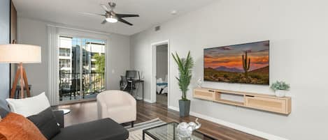 Stylish living room with comfortable double sofa bed, working station, dining area.