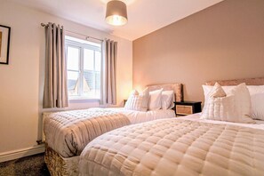 Bedroom 1 with a comfortable zip link bed which is configured as two single beds by default or can be zipped together to form a king-size bed upon request. Fresh linen and towels are provided.