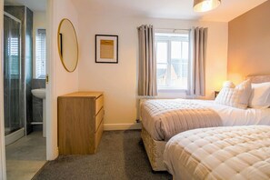 Bedroom 1 with a comfortable zip link bed which is configured as two single beds by default or can be zipped together to form a king-size bed upon request. Fresh linen and towels are provided.