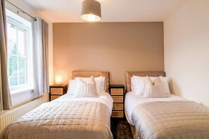 Bedroom 1 with a comfortable zip link bed which is configured as two single beds by default or can be zipped together to form a king-size bed upon request. Fresh linen and towels are provided.