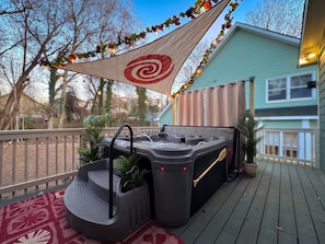 Relax in our Moana-inspired 7-seater hot tub, complete with a sail, tropical flowers, string lights, and a privacy curtain. A dreamy escape awaits on the back patio! 🌊✨ #OnceUponAGem