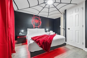 "Experience a room where style meets adventure. Black and red accents with a stunning web ceiling design! 🕷️ #WebbedDesign #ComicRoomGoals #SuperheroStyle"