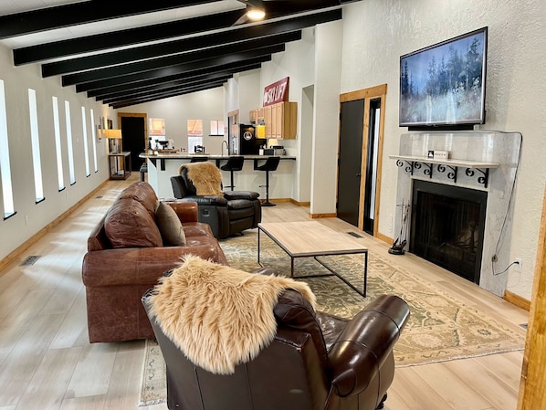 Spacious living area featuring a cozy wood-burning fireplace and rustic charm—perfect for relaxing after a day of exploring Ruidoso.