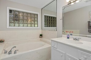 The guest bathroom offers a bath tub as well as a walk in shower.