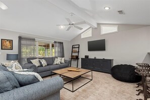 The living room offers two comfortable couches and a flat screen TV.