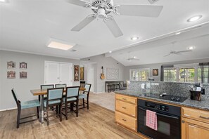 This home offers an open concept kitchen, dining area, and living room.
