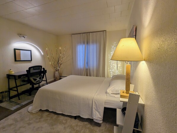 Bedroom #1: Queen bed, nightstand, closet, and a desk with chair for work.