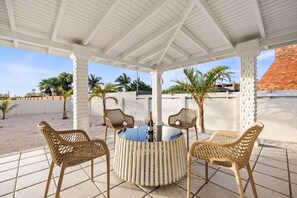 Relax under the shade of a stylish porch, offering a perfect spot for lounging or dining while enjoying the surrounding nature.