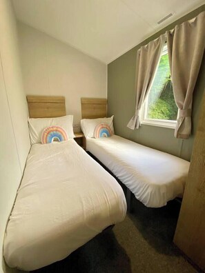 third bedroom with twin beds and a wardrobe 