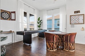 Bright and airy game area with large windows, offering natural light and a scenic view while you enjoy hours of fun and entertainment.