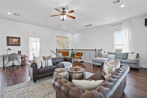 Cozy upstairs living area, designed for comfort and relaxation, offering a peaceful retreat with inviting seating and a warm, welcoming ambiance.