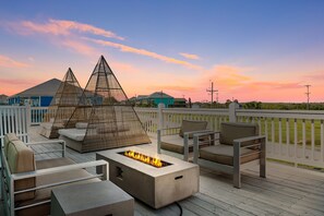 Unwind in style with this stunning outdoor lounge space featuring cozy seating and a sleek fire pit.
