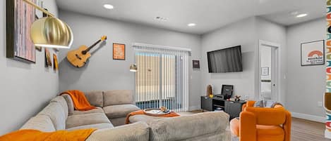 The Open Living Area is Filled with Natural Light and Boasts Chic Furnishings, Creating an Inviting Atmosphere for Both Relaxation and Entertainment.