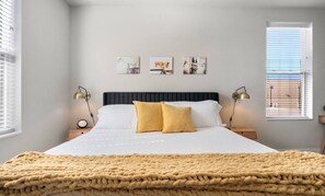 Your Master Suite, a Luxurious Haven Designed For Ultimate Relaxation. Featuring a Plush King-Size Bed Adorned with Soft, Comfy Blankets. This Spacious Retreat Invites You to Unwind and Recharge. A Calming Ambiance for a Restful Night's Sleep.