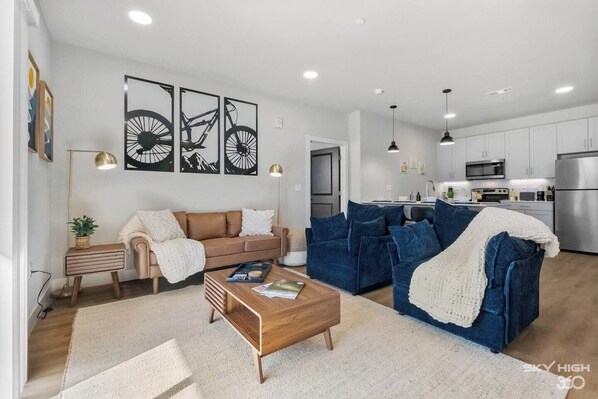 The Open Living Area is Filled with Natural Light and Boasts Chic Furnishings, Creating an Inviting Atmosphere for Both Relaxation and Entertainment.