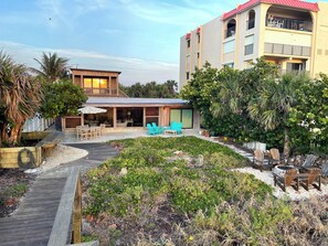 Outdoor shower and hose are located beside the beach access walkway.