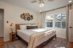 Bedroom 1 features a king bed, ceiling fan, blackout curtains