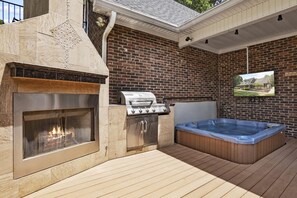 Our expansive deck boasts a BBQ grill, outdoor fireplace, and hot tub, perfect for enjoying the outdoors in comfort and style all season long.