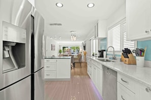 A complete kitchen with a gas oven and stove for precise cooking, a microwave for quick meals, a fridge for storing fresh ingredients, and a hood fan for ventilation. Your culinary adventures begin here.