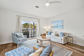 Living room with sleeper sofa, smart TV and balcony with dining table
