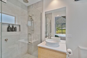 Stunning ensuite bathroom connected to bedroom one with shower and heated floors.