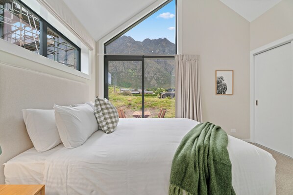 Master bedroom with king size bed and outlook towards The Remarkables.