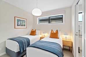 Bedroom two features two single beds. 
