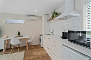 A kitchenette with Fridge, convection/microwave oven, toaster, kettle and Nespresso pod machine.