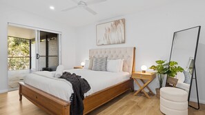 Sleep like royalty in the spacious main bedroom, featuring a luxurious king bed and soothing design
