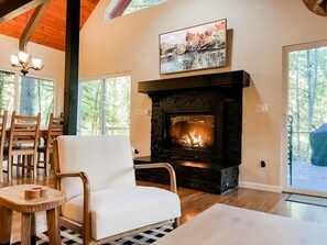 Living room has a gas fireplace and smart TV