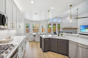 Featuring a gas cooktop and pantry, this kitchen is designed for convenience and culinary creativity.