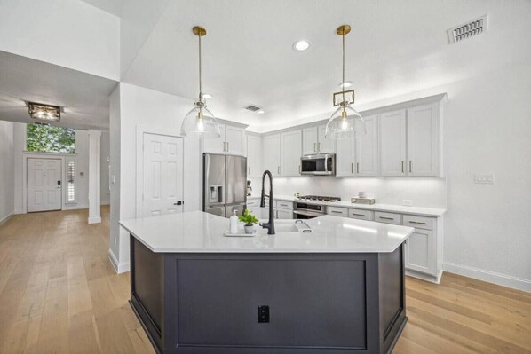 The large kitchen island provides ample space for meal prep or gathering with family and friends.