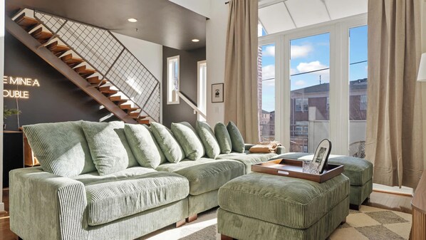 Make yourself at home in this bright and cozy living room with a comfy sofa and TV to unwind.