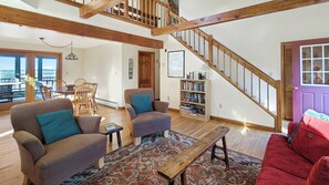 Living room with comfortable seating and staircase to second floor