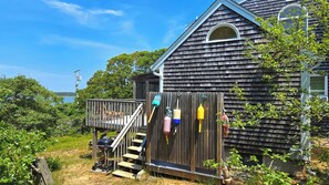 Enclosed outdoor shower and steps to deck