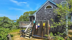 Enclosed outdoor shower and steps to deck
