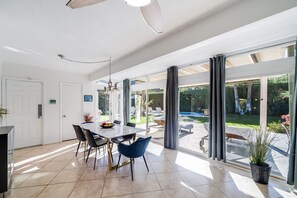 Dining area. Opens onto the kitchen and living room. Sliding doors opening to the pool area.