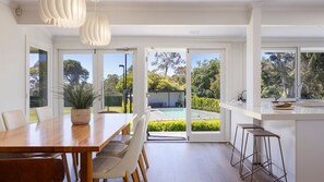 Kitchen and dining looking over the pool and tennis court 