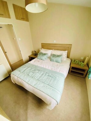 master bedroom with walk in wardrobe, tv and ensuite 