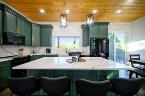 The chic, open kitchen offers ample space & all the comforts of home