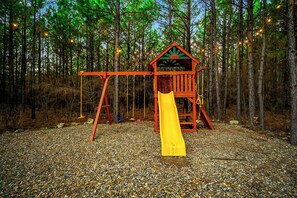 Playtime Paradise: Adventure awaits on this charming playset under twinkling string lights!