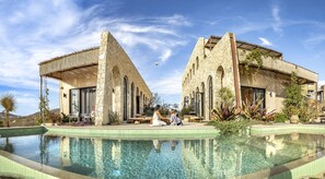The home is built alongside two mystical acueduct walls - perfect for gatherings
