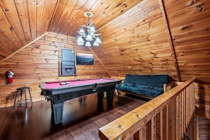 Enjoy endless entertainment in the game room, featuring a pool table and a Smart TV, creating the perfect space for relaxation and fun.