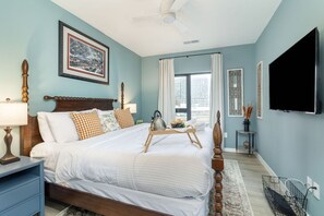 Primary bedroom: King-size bed with smart TV and unattached bathroom with walk-in shower.